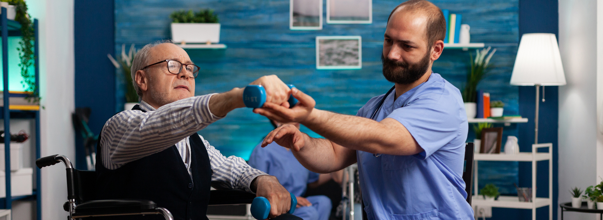 injury rehabilitation physiotherapist working with man in wheelchair